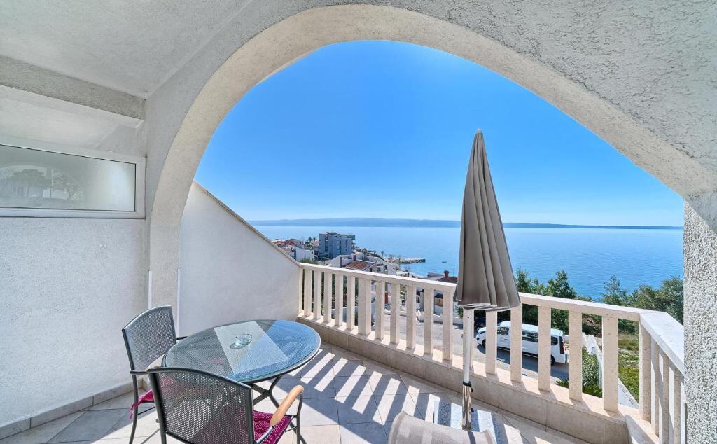 Arched balcony with table and sea view